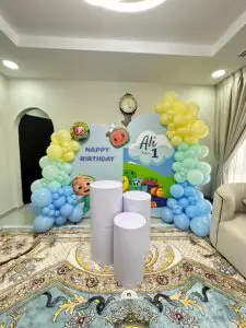 Cocomelon-themed birthday decoration featuring colorful balloons, character cutouts, and playful props inspired by the popular kids’ show, perfect for toddlers’ celebrations.
