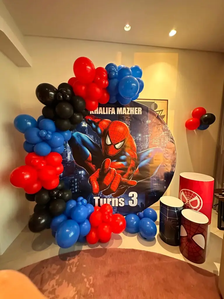Spider-Man theme decoration featuring red and blue balloons, superhero cutouts, and comic-style props, perfect for a fun and action-packed birthday party.