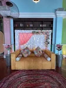 Floral stage decoration with flower arrangements and backdrop setup.